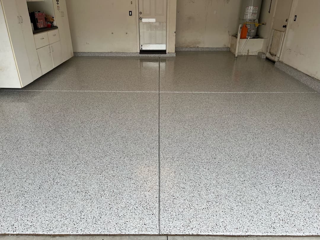 Epoxy-coated garage floor with a polished finish in a clean, organized space.