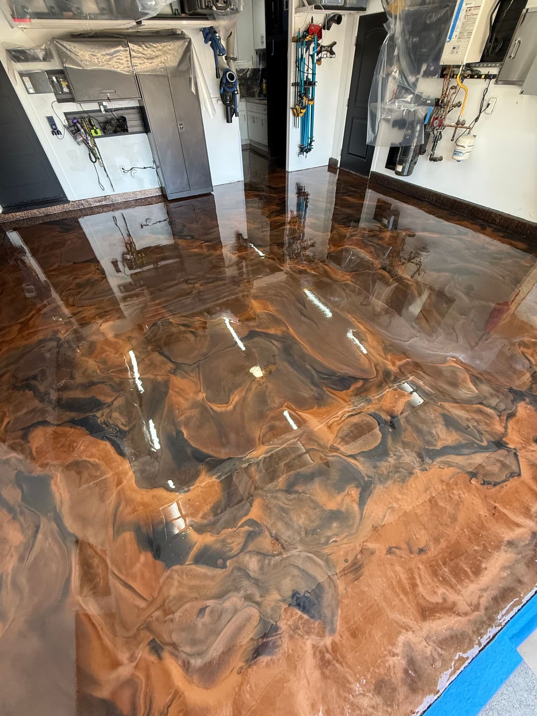 Epoxy resin floor with swirls of brown and black in a modern garage setting.